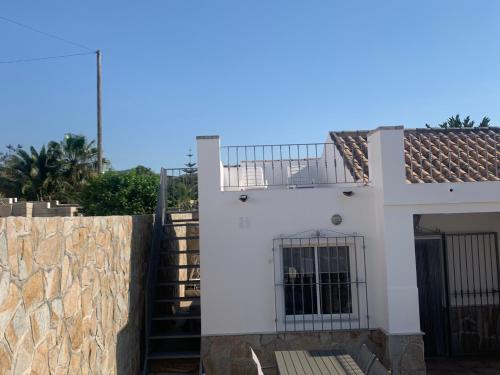 a white house with a balcony and a fence at Casa Olivia villa in Arboleas