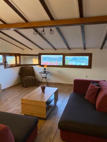 a living room with a couch and a coffee table at Ξενώνας Κερκινίτης in Lithótopos