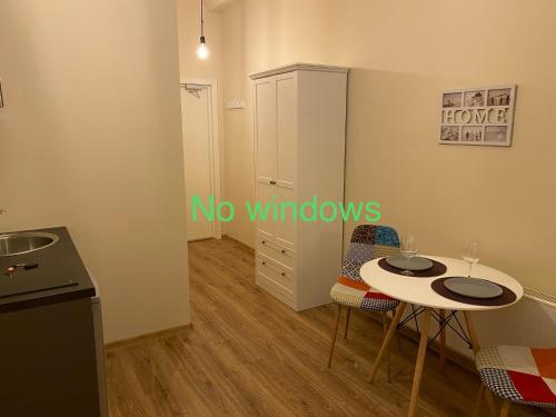 a small kitchen with a table and two chairs at Kastanimaja Apartments in Tartu