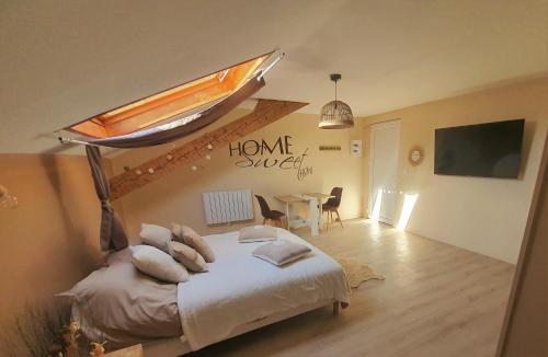 a bedroom with a bed with a skylight and a table at "Le Petit Paradis" au Centre Ville d'Oyonnax in Oyonnax