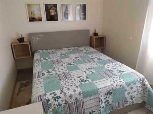 a bedroom with a bed with a quilt on it at Casa da Rota dos Moinhos in Lousã