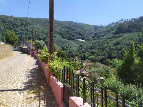a fence with a view of a mountain at Casa da Rota dos Moinhos in Lousã