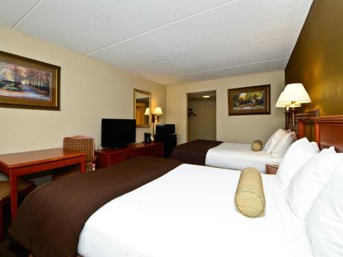 a hotel room with two beds and a television at Ramada by Wyndham Plymouth Hotel & Conference Center in Plymouth