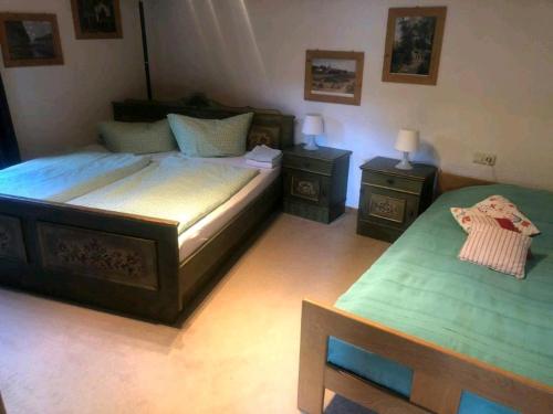 una camera da letto con due letti e due comodini di Ferienwohnung Familie Schaefer a Schmallenberg