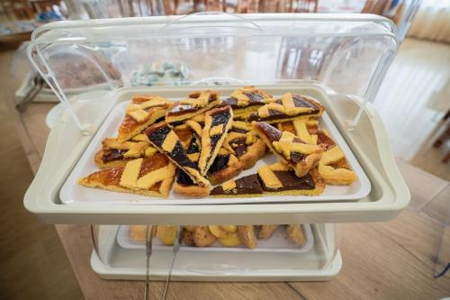 a refrigerator with a tray of food in it at Hotel Happy in Milano Marittima
