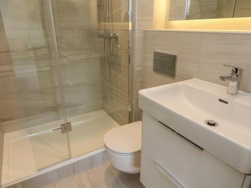 a bathroom with a shower and a toilet and a sink at The Works in Cononley