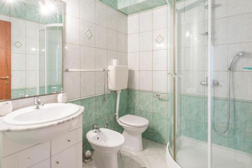 a bathroom with a sink and a toilet and a shower at Historic center Hvar town- a few steps from the main square in Hvar