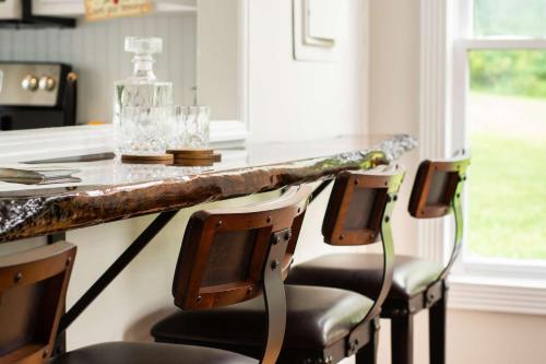 a kitchen with a counter with two chairs and a table at Colonial Manor in Spring Hill