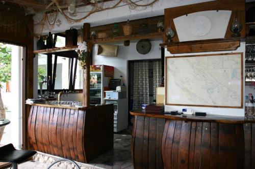 a kitchen with a counter and a map on the wall at Guest House Frane in Pag