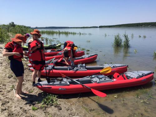 a group of people standing next to a group of kayaks at Belegis Villa in Stari Banovci