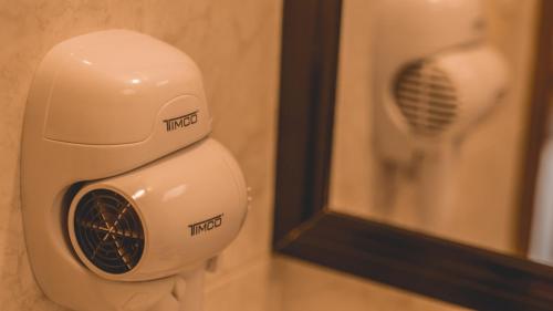 a hair dryer is sitting next to a mirror at Hotel Aurora in Oaxaca City