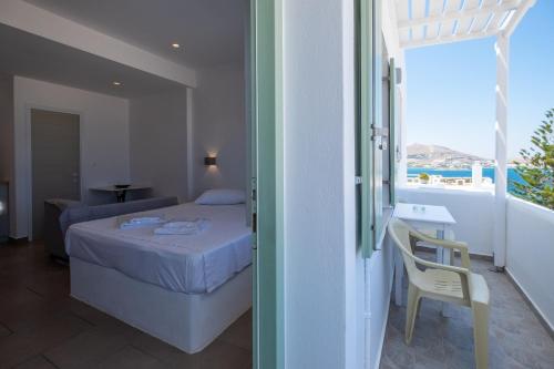 A bed or beds in a room at Lorenzo Studios and Suites Paros