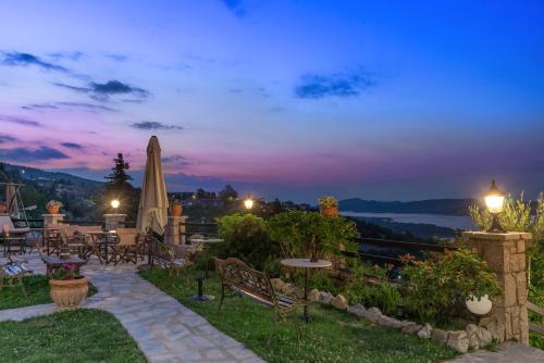 a patio with tables and chairs at night at Archontiko Zakoni in Neochori