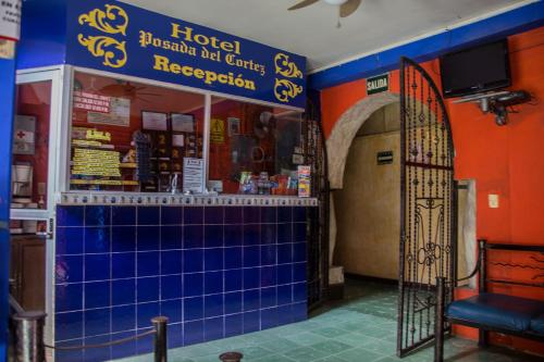 a hotel restaurant with blue tiles and a gate at HOTEL POSADA DEL CORTEZ in La Paz