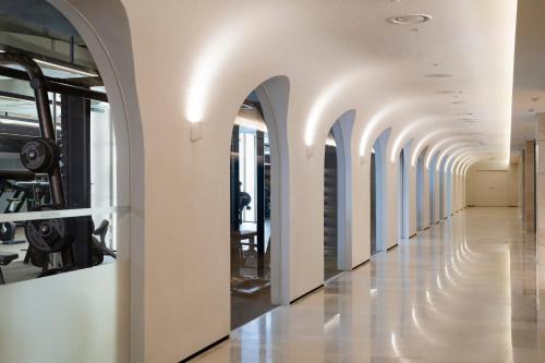 a hallway of an office building with white walls and arches at Mondrian Seoul Itaewon in Seoul