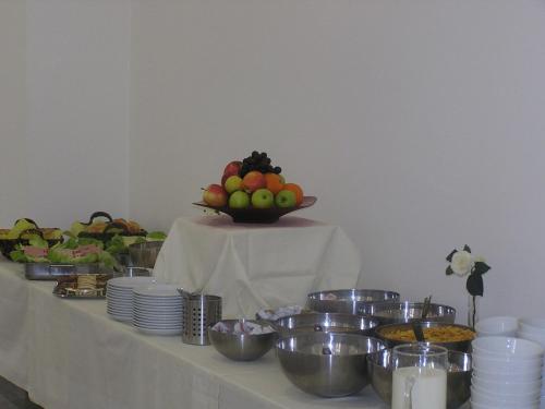 a table with a bowl of fruit and a plate of food at Hotel City Residence in Vienna