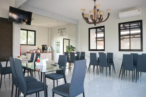 a dining room with a table and blue chairs at Home resort in Phitsanulok