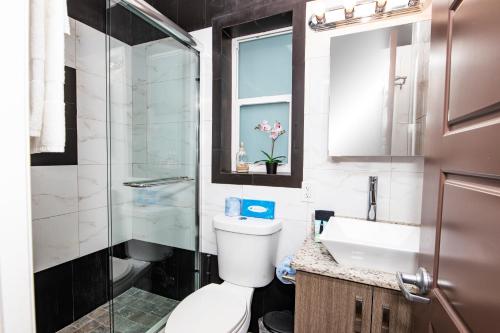 a bathroom with a toilet and a sink and a shower at Caribbean Resort by the Ocean in Hollywood