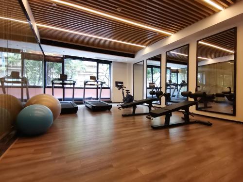 a gym with treadmills and exercise equipment in a room at Paco Hotel BeiJing Road Metro Guangzhou-Free Shuttle Bus For Canton Fair in Guangzhou