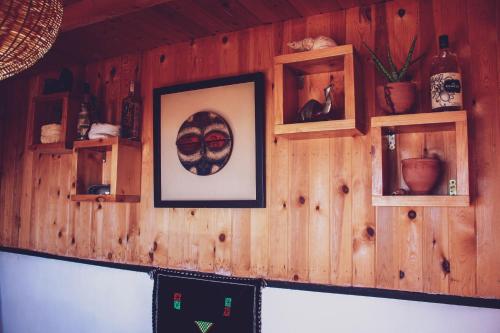 a wooden wall with shelves and a picture on it at Afer Surf Hostel in Imsouane