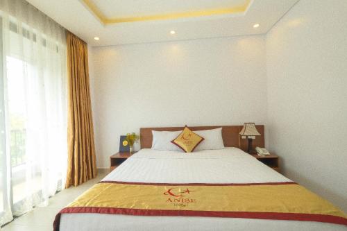 a bedroom with a bed and a large window at Anise hotel in Phu Quoc