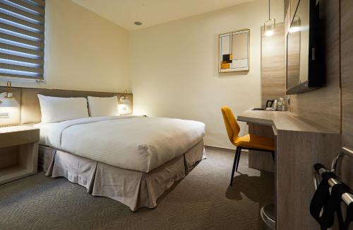 Postel nebo postele na pokoji v ubytování Hai Fu Hotel & Suites