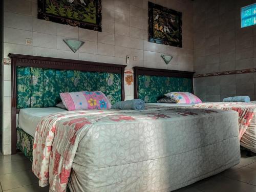a bedroom with two beds in a room at Kerti Beach Bungalow and Restaurant in Padangbai