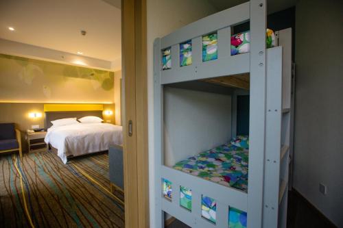 a bunk bed in a room with a bedroom at Holiday Inn Express Emei Mountain by IHG in Emeishan