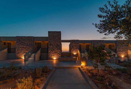 a house with a pathway in front of it at night at Achilles Hill Hotel in Methoni