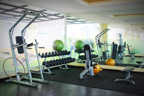 a gym with exercise equipment in a room at The Icon Place 1 @ Central Pattaya in Pattaya