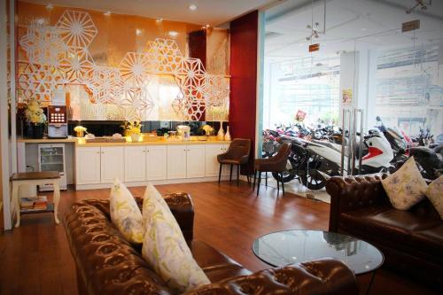 a living room with a couch and a kitchen with motorcycles at The Icon Place 1 @ Central Pattaya in Pattaya