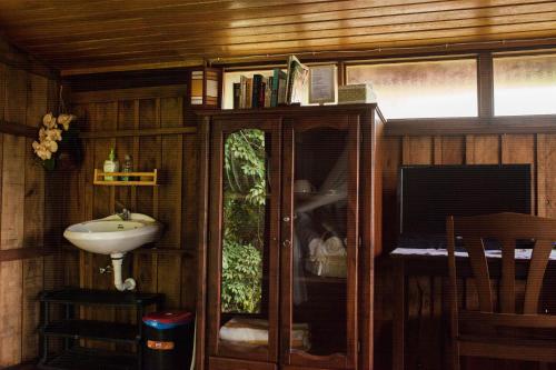 a bathroom with a sink and a mirror at Fox Hill in Kuah
