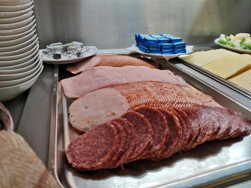 a tray of meat and sausage on a buffet at HOTEL SVRATKA in Svratka