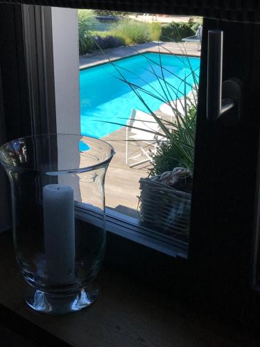 a glass vase sitting on a window sill with a candle at Schittlerhaus in Oberstdorf