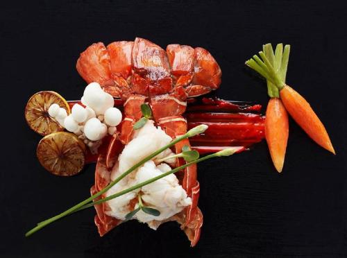 a lobster with carrots and other vegetables on a table at Vivanta Guwahati in Guwahati