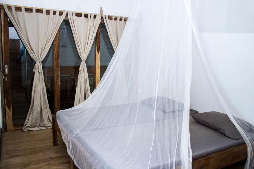 Кровать или кровати в номере BK Homestay, Batukaras