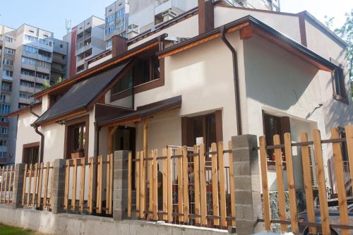 a house with a wooden fence in front of it at Sofia Family House - Free Parking in Sofia