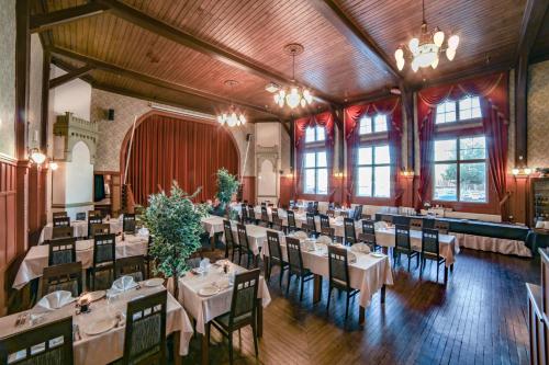 a dining room with tables and chairs in it at Hotelli-Ravintola Alma in Seinäjoki