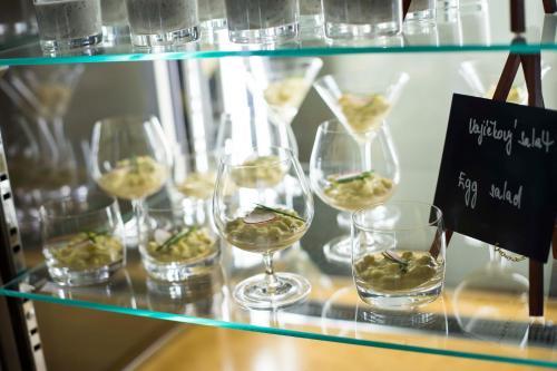 a bunch of glasses of wine on a shelf at Mercure Ostrava Center in Ostrava