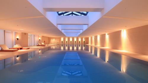 a swimming pool with lights in a building at Holiday Inn Nantong Oasis International, an IHG Hotel in Nantong