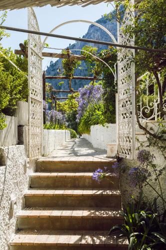 a set of stairs leading to a garden with flowers at Villa La Pergola Capri in Capri