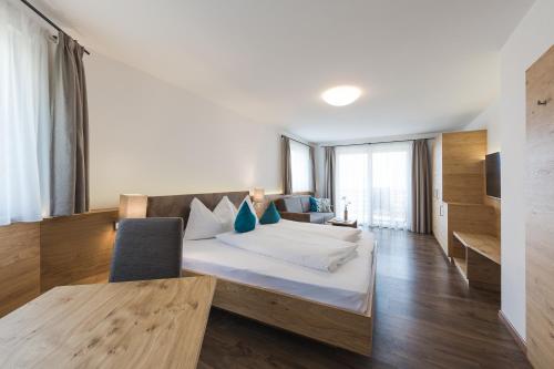 ein Hotelzimmer mit einem Bett und einem TV in der Unterkunft Apparthotel Zunneler in Schenna
