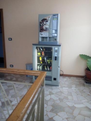 a refrigerator with a microwave on top of it at affitacamere zimmer nadia in Chiuppano