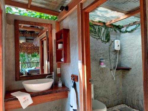 a bathroom with a sink and a mirror at Nature Hill in Koh Mook