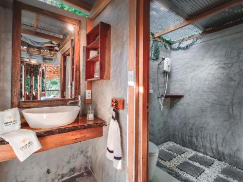 a bathroom with a sink and a toilet at Nature Hill in Koh Mook