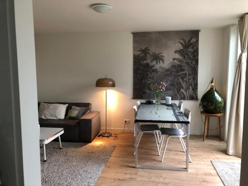 a living room with a table and a couch at Savina City Centre Apartment Near Beach, Station and Shops in Zandvoort