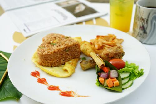 a white plate with food on a table at Regantris Surabaya in Surabaya