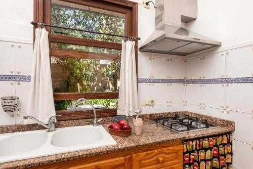a kitchen with a sink and a window at Ca'n Marinero in Porto Cristo