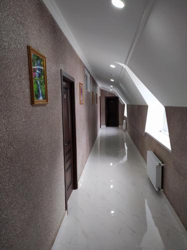 a hallway of a building with a window and a stair case at Gold Hotel Quba in Quba