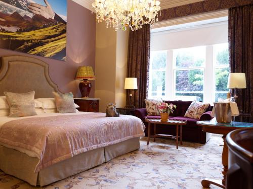 a bedroom with a bed and a chandelier at The Bird, Bath in Bath